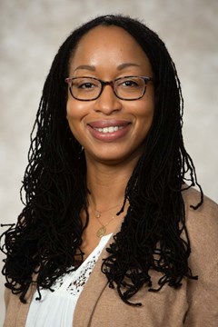 Photo of Jessica Danley: Black woman with long thin braids and glasses.