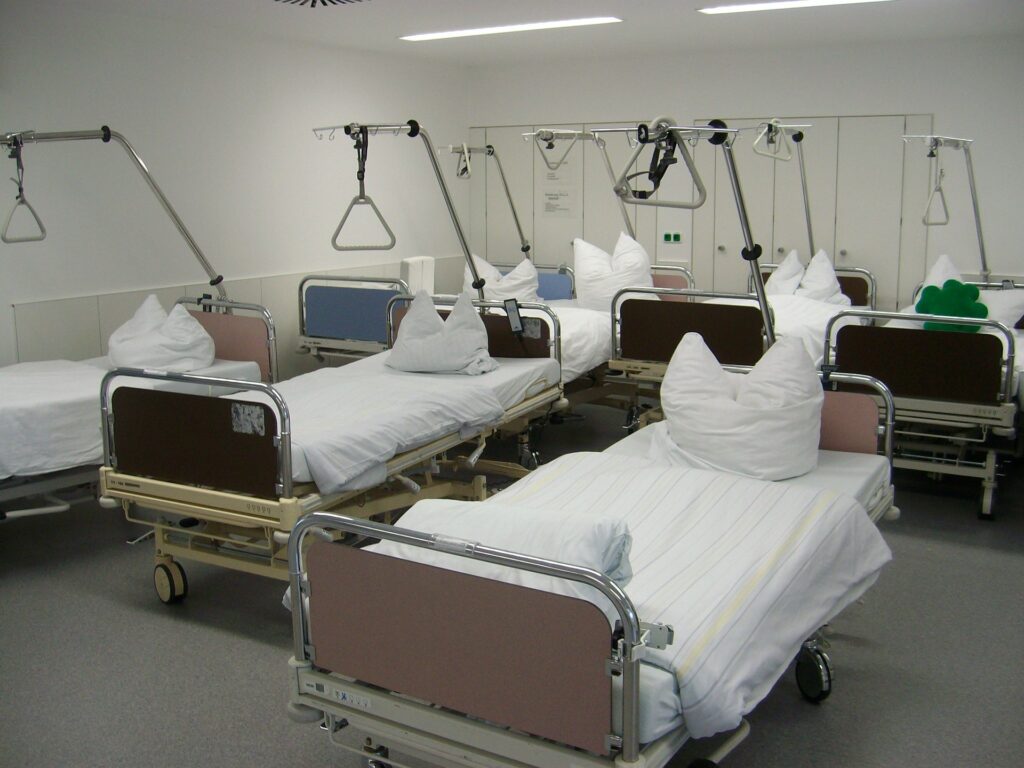 room of hospital beds with hoyer lifts