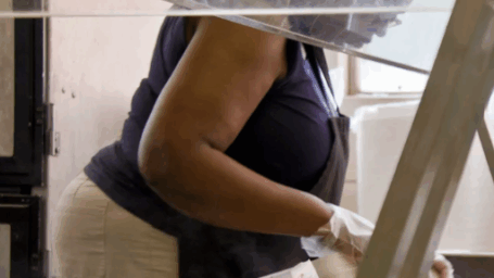 Cafeteria worker preparing food