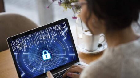 young lady looking at laptop showing padlock implying security