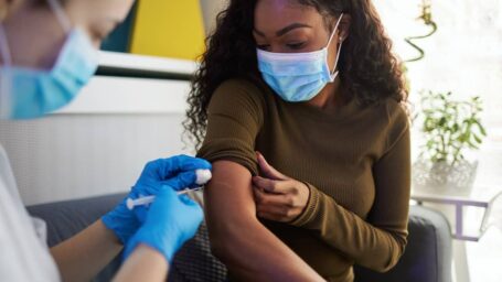 African family get vaccinated at home during pandemic times.