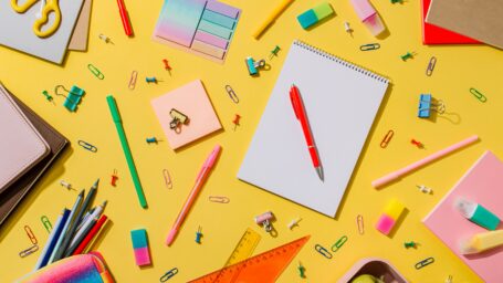 Set of school supplies, stationery accessories. Education, freelance concept. Bright yellow wood background. Flat lay or top view